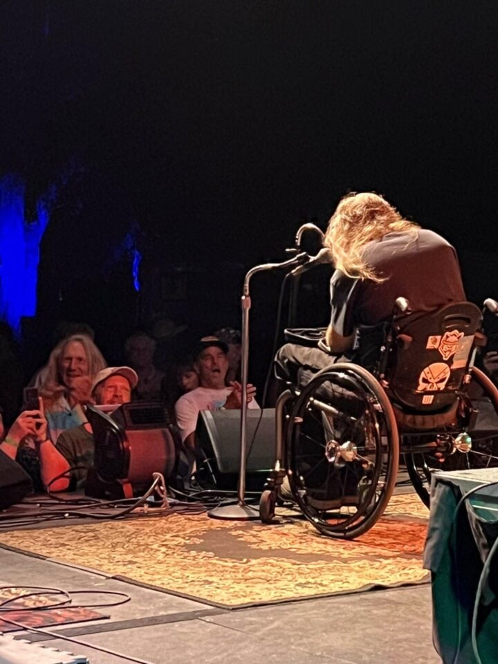 Picture from on stage, behind Johnny Wheels, capturing an enthusiastic crowd.