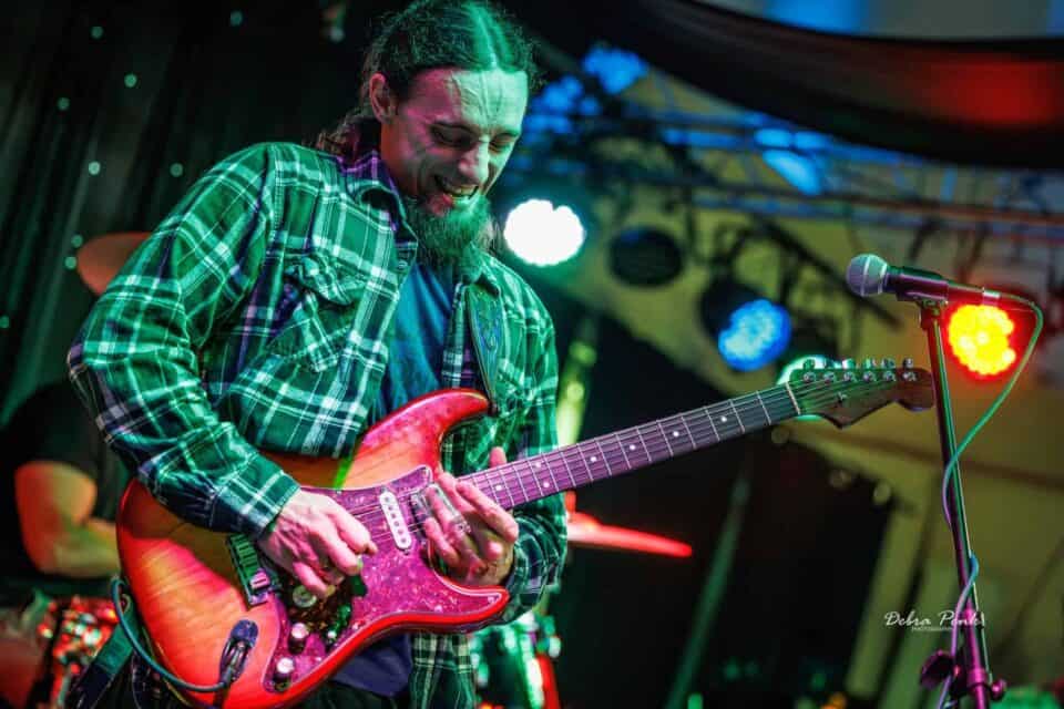 Brandon Logan playing his guitar high on the neck.