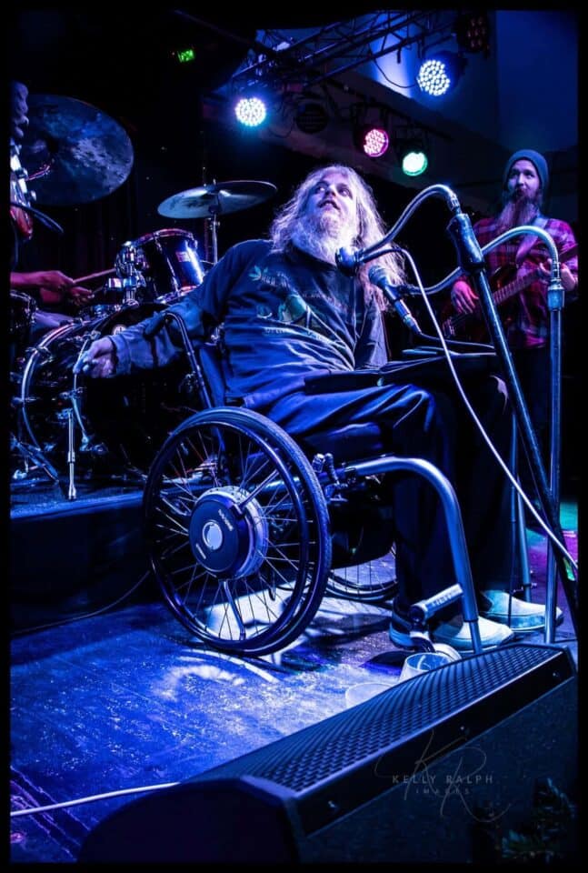 Johnny and Taylor looking up at the big screen (out of the picture) while playing a song.